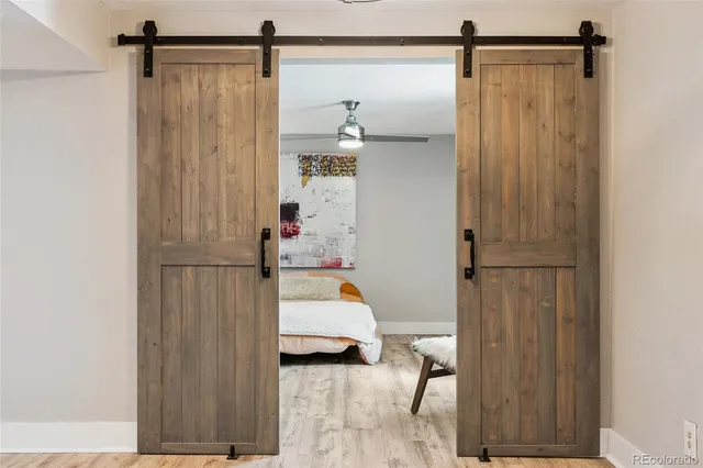 a bedroom with a bed and wooden floor