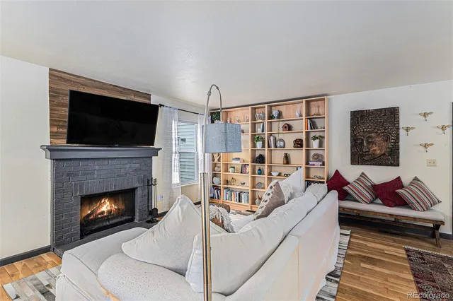 a living room with furniture and a fireplace