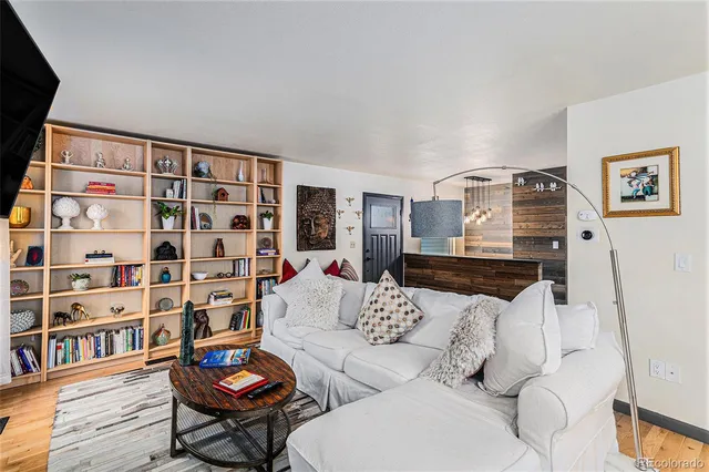 a living room with furniture and a book shelf