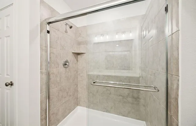 a bathroom with a glass shower door