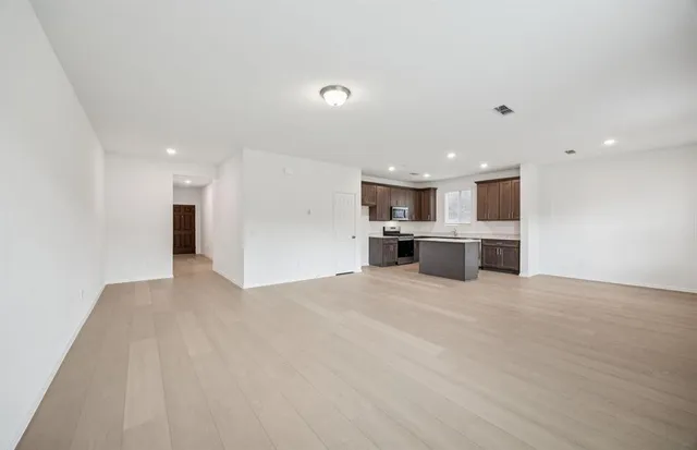 a view of a kitchen with a sink and a refrigerator