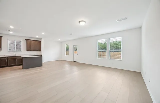 a view of a kitchen with a sink a dishwasher and a large window