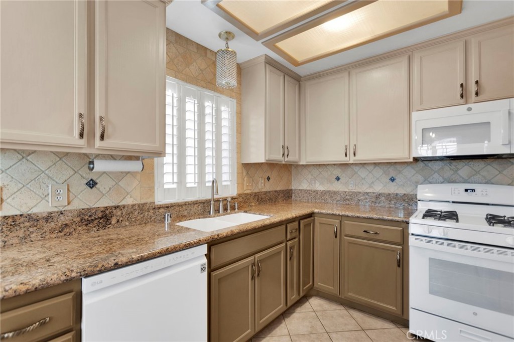 19055 Stoddard Way Apple Valley, CA 92308 - Photo 11 of 44 a kitchen with granite countertop white cabinets and white stainless steel appliances