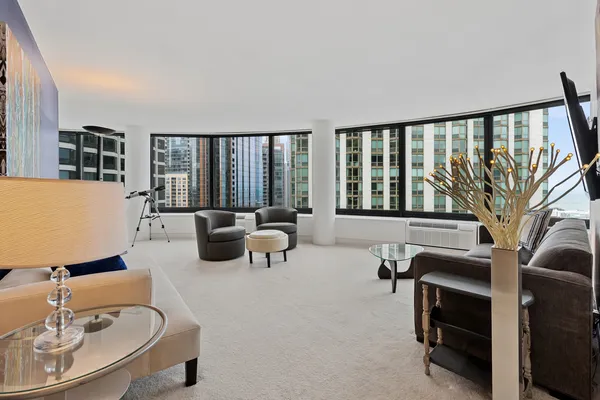 a living room with furniture and a floor to ceiling window