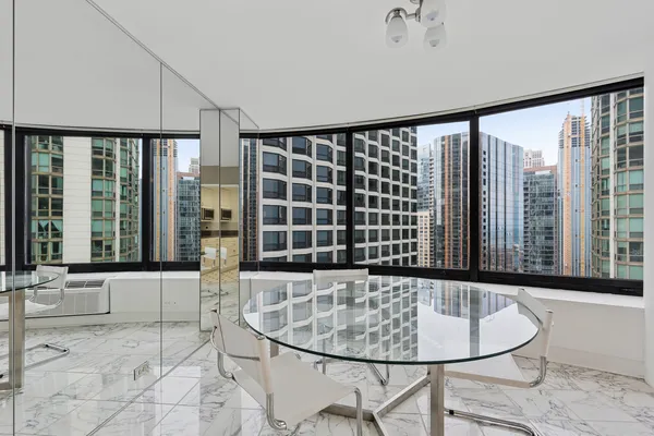 a view of a living room and floor to ceiling window and furniture