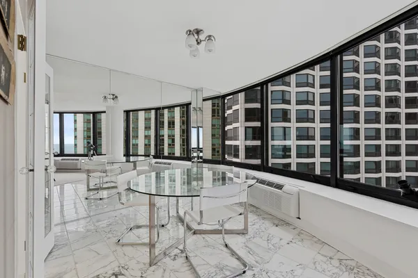 a large white kitchen with a large window