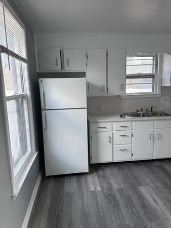 a white refrigerator freezer sitting in a kitchen