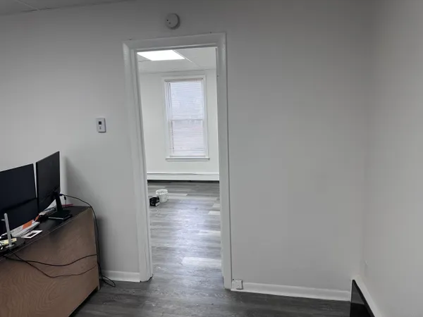 a view of room with wooden floor and cabinet