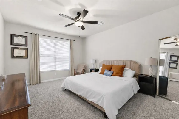 a bedroom with a bed and window