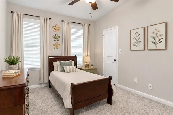 a bedroom with a bed and a potted plant
