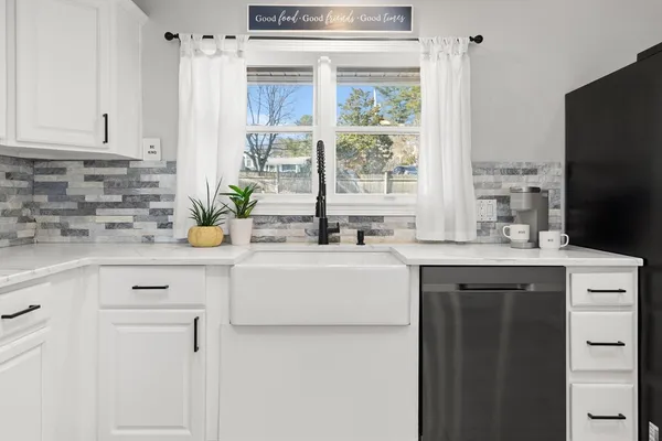 a kitchen with a sink stove and cabinets