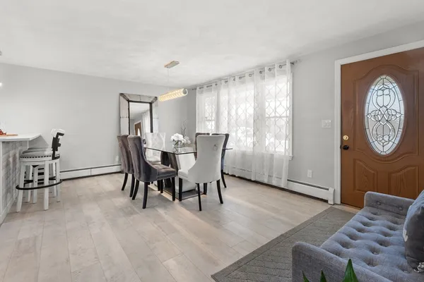 a view of a livingroom with furniture window and wooden floor