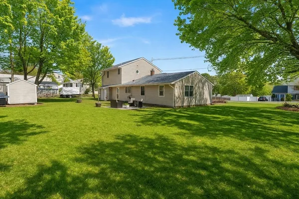 a front view of house with yard and green space