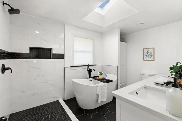 a bathroom with a sink a toilet and shower