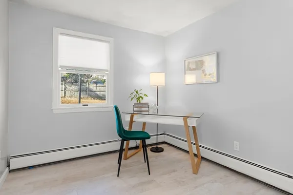 a view of a workspace with furniture and a window