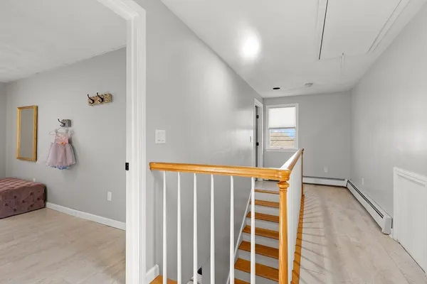a view of a hallway with closet and a window