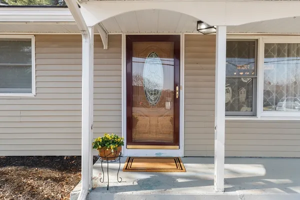 a front view of a house with a potted plant