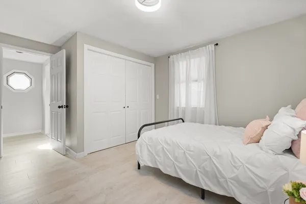 a bedroom with a bed and a window