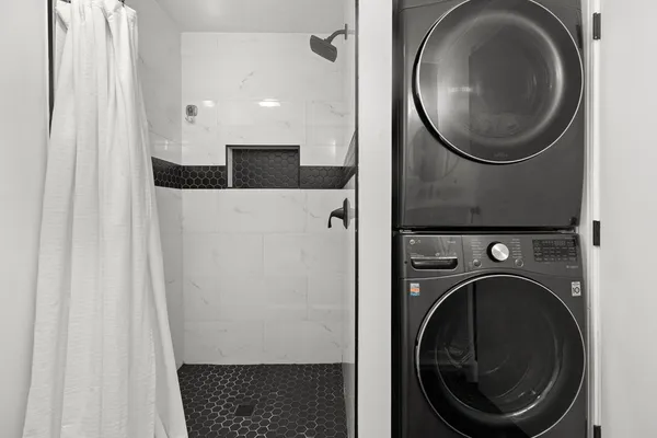a view of a hallway with washer and dryer