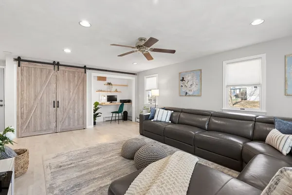 a living room with furniture and a chandelier
