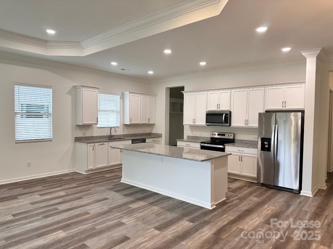 6654 Star Drive, Unit 8 Sherrills Ford, NC 28673 - Photo 2 of 7 a kitchen with white cabinets and stainless steel appliances