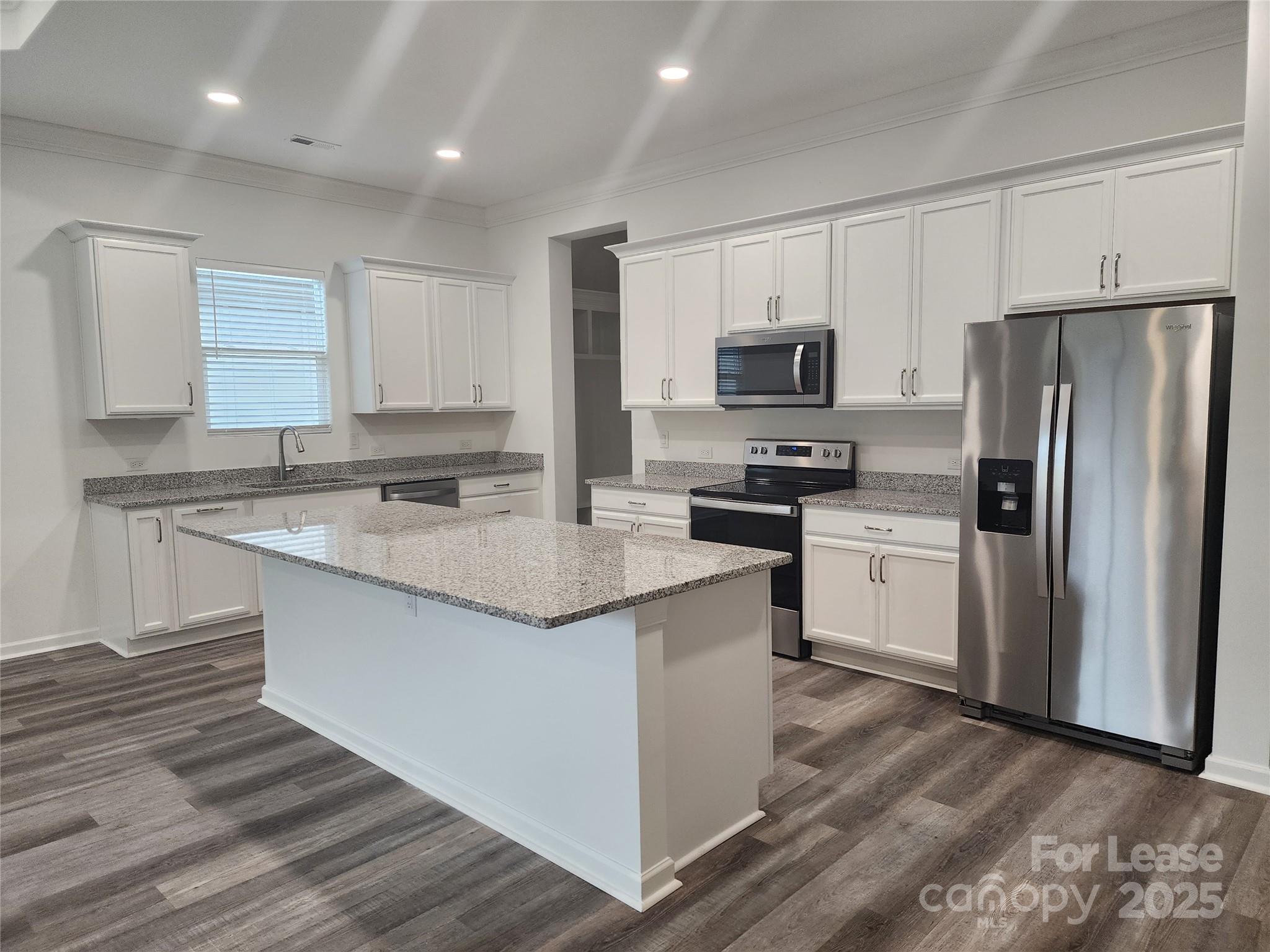 6654 Star Drive, Unit 8 Sherrills Ford, NC 28673 - Photo 3 of 7 a kitchen with stainless steel appliances granite countertop a refrigerator sink and microwave