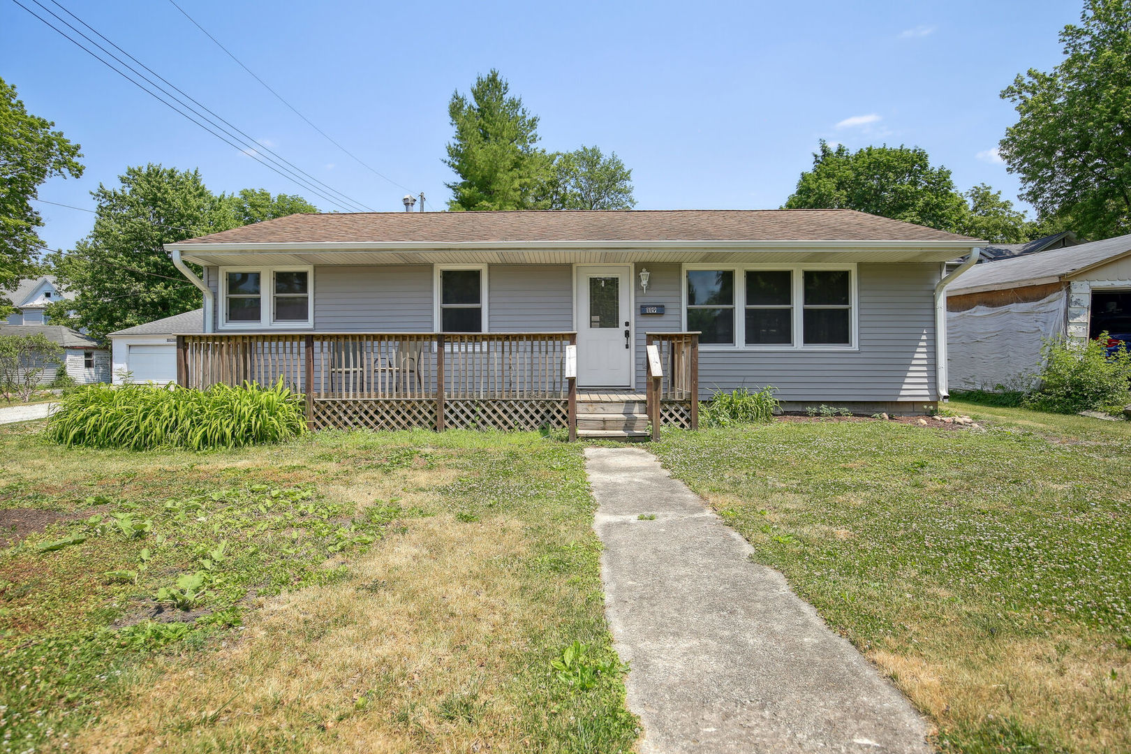 a front view of house with yard and green space