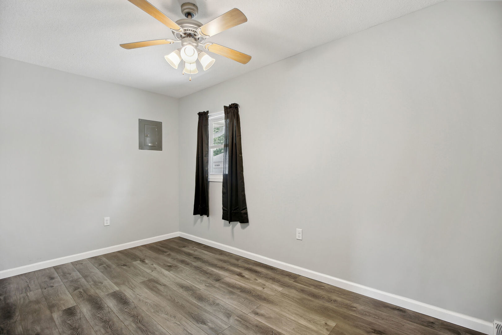 119 South Maple Street Paxton, IL 60957 - Photo 11 of 22 an empty room with a chandelier fan and windows