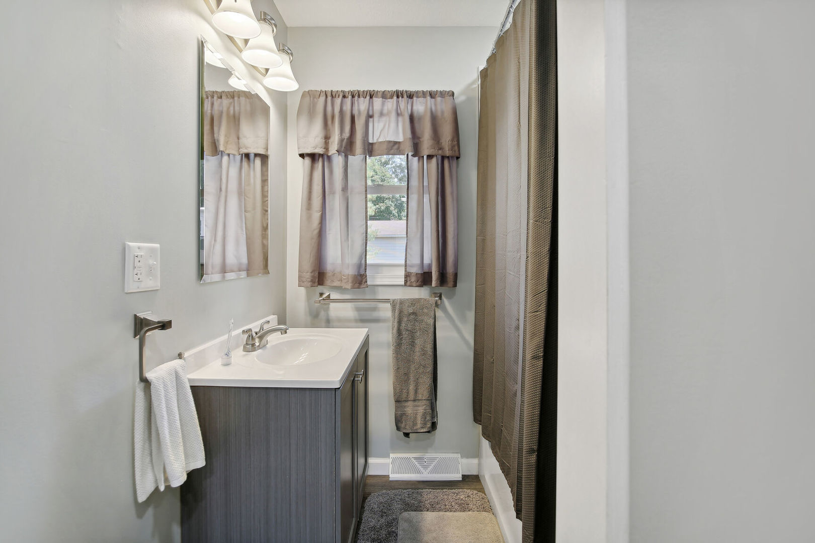 119 South Maple Street Paxton, IL 60957 - Photo 16 of 22 a bathroom with a sink a mirror and a shower