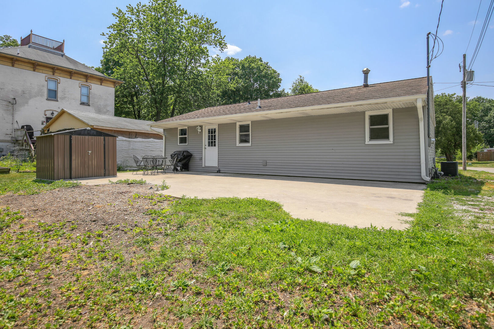 119 South Maple Street Paxton, IL 60957 - Photo 21 of 22 a house that is sitting in the grass with large windows