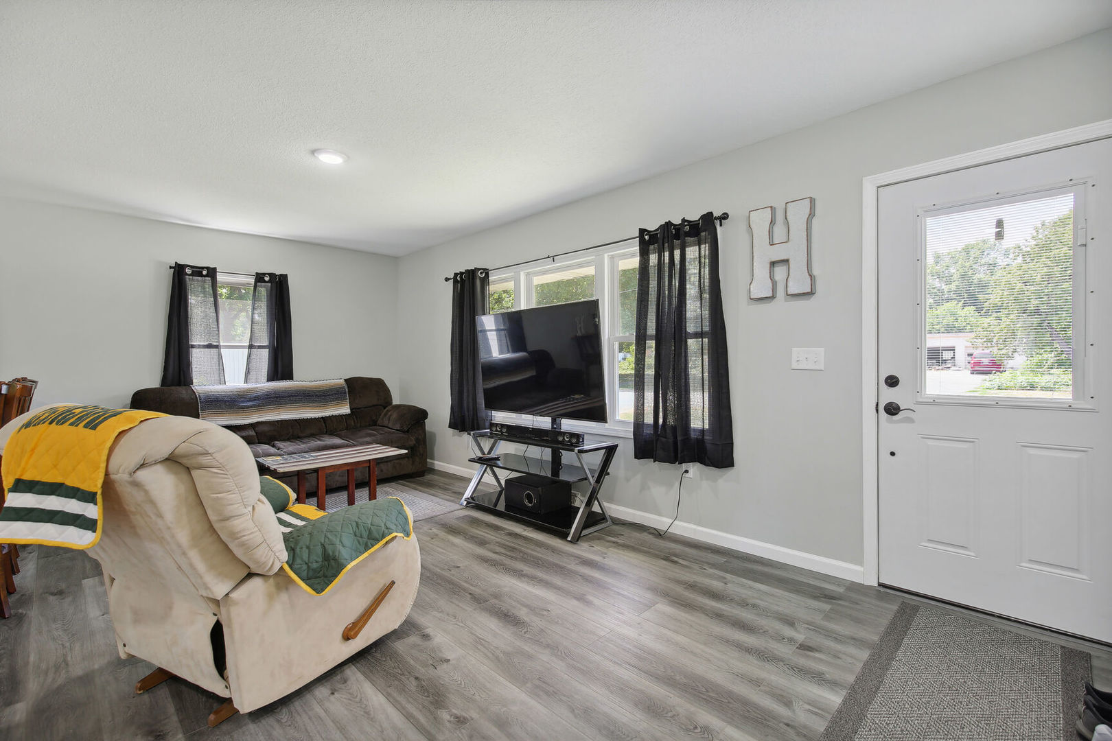 119 South Maple Street Paxton, IL 60957 - Photo 4 of 22 a living room with furniture and a flat screen tv