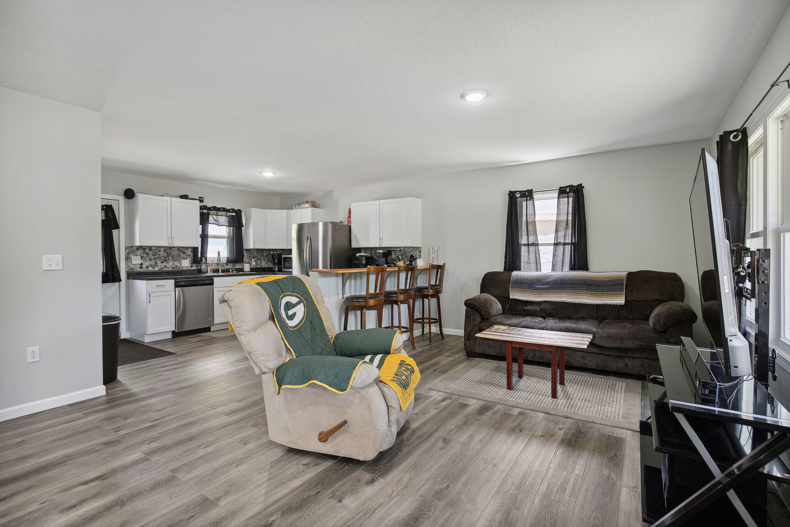 119 South Maple Street Paxton, IL 60957 - Photo 5 of 22 a living room with furniture and a dining table with kitchen view