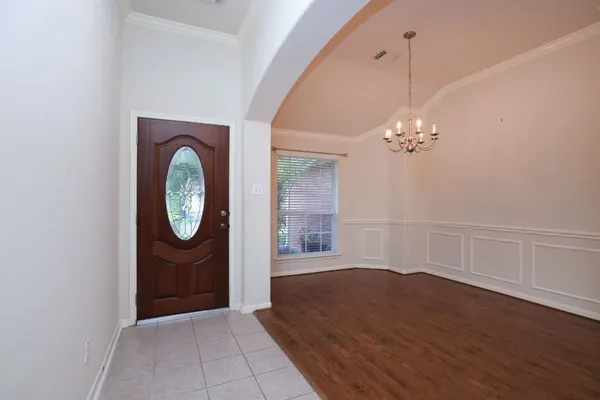 a view of a room with wooden floor and white walls