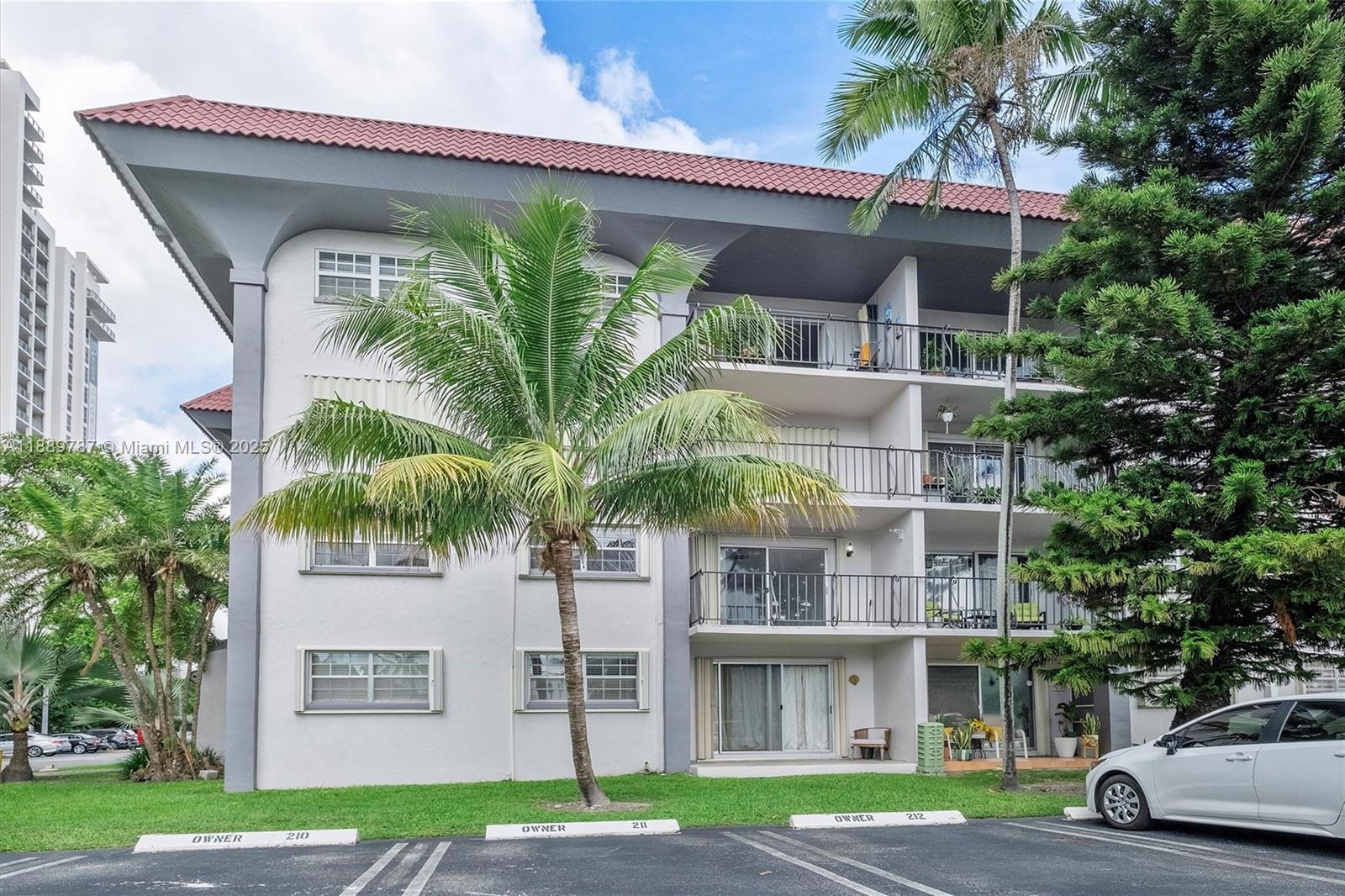 8107 Southwest 72nd Avenue, Unit 201E Miami, FL 33143 - Photo 1 of 29 a front view of a building with garden