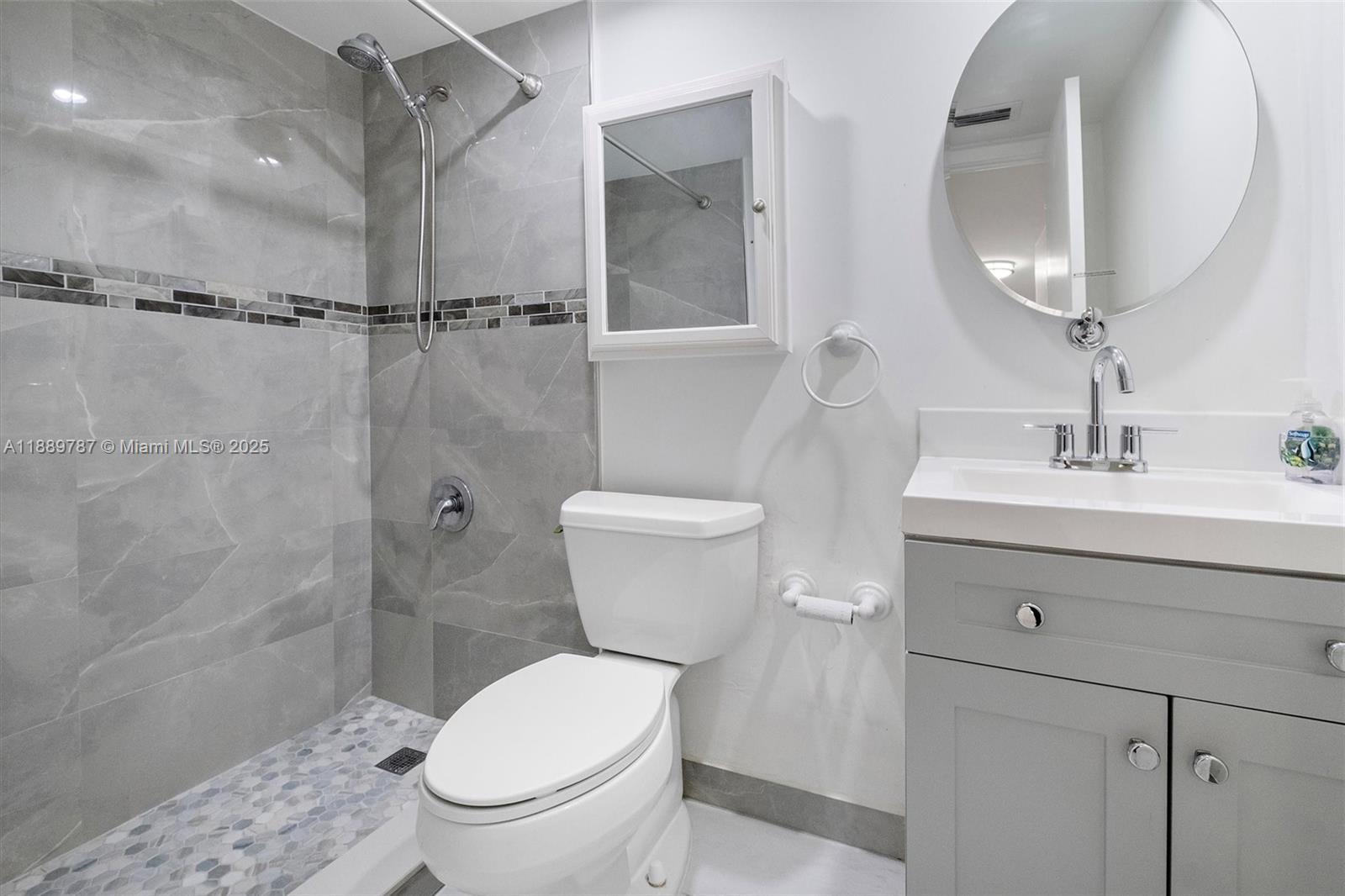 8107 Southwest 72nd Avenue, Unit 201E Miami, FL 33143 - Photo 17 of 29 a bathroom with a toilet a sink and shower