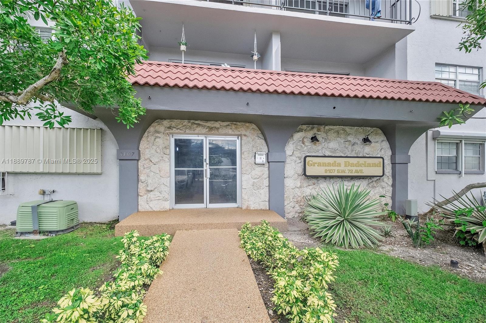 8107 Southwest 72nd Avenue, Unit 201E Miami, FL 33143 - Photo 18 of 29 a front view of a house with garden
