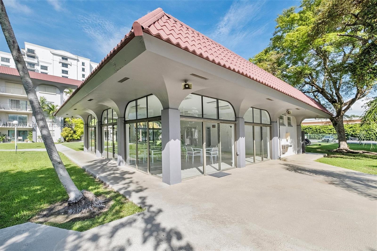 8107 Southwest 72nd Avenue, Unit 201E Miami, FL 33143 - Photo 20 of 29 a front view of a house with a garden