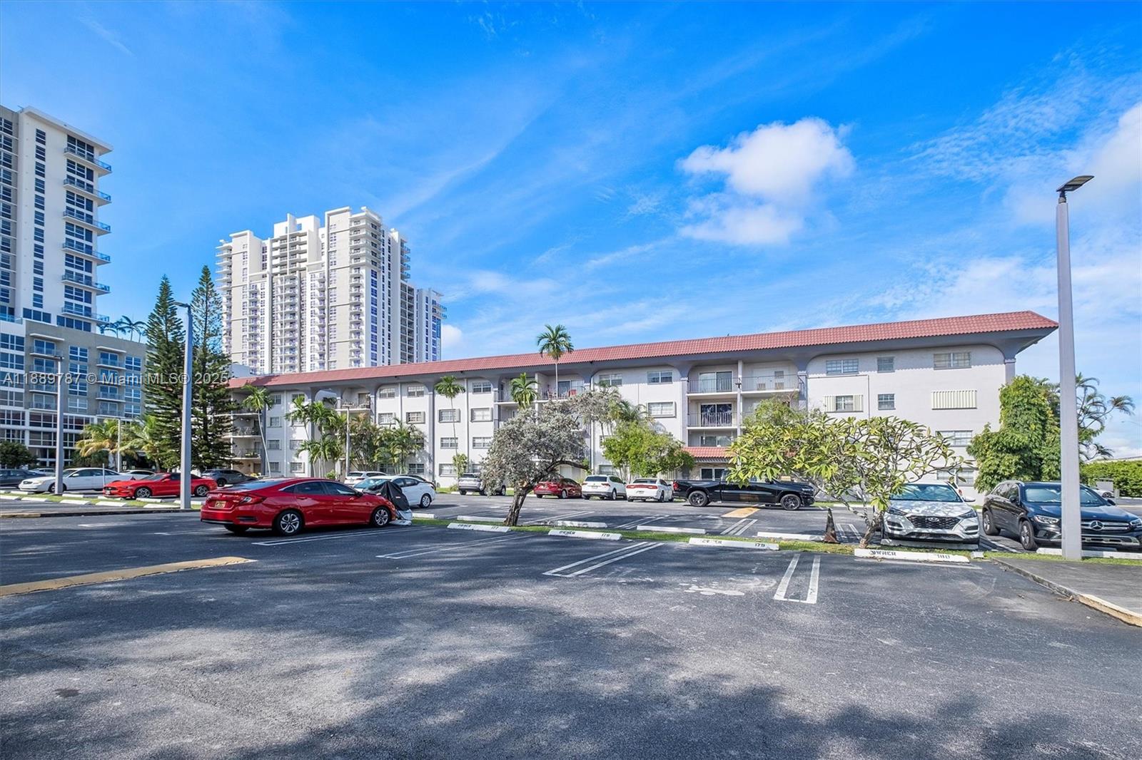 8107 Southwest 72nd Avenue, Unit 201E Miami, FL 33143 - Photo 23 of 29 a cars parked in front of a building