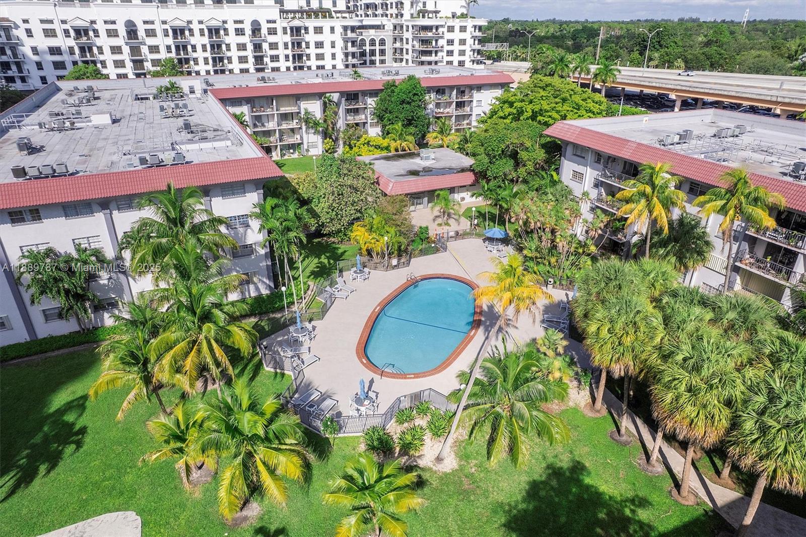 8107 Southwest 72nd Avenue, Unit 201E Miami, FL 33143 - Photo 24 of 29 an aerial view of a house with a yard and a bench