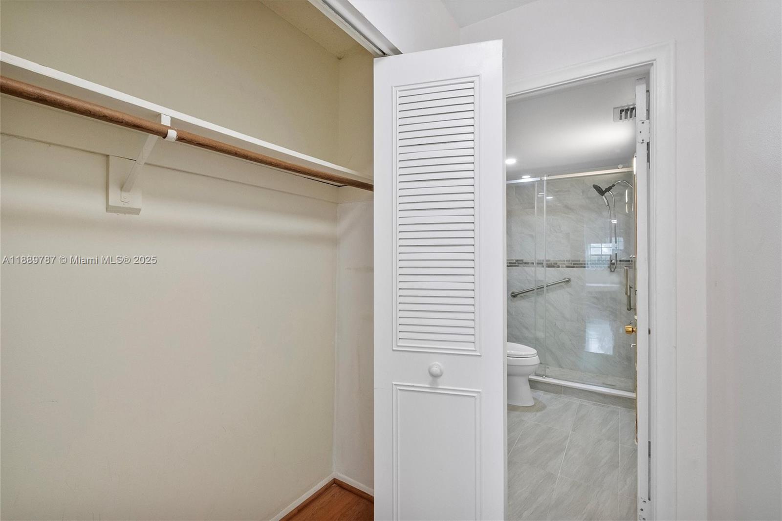 8107 Southwest 72nd Avenue, Unit 201E Miami, FL 33143 - Photo 9 of 29 a bathroom with a glass shower door