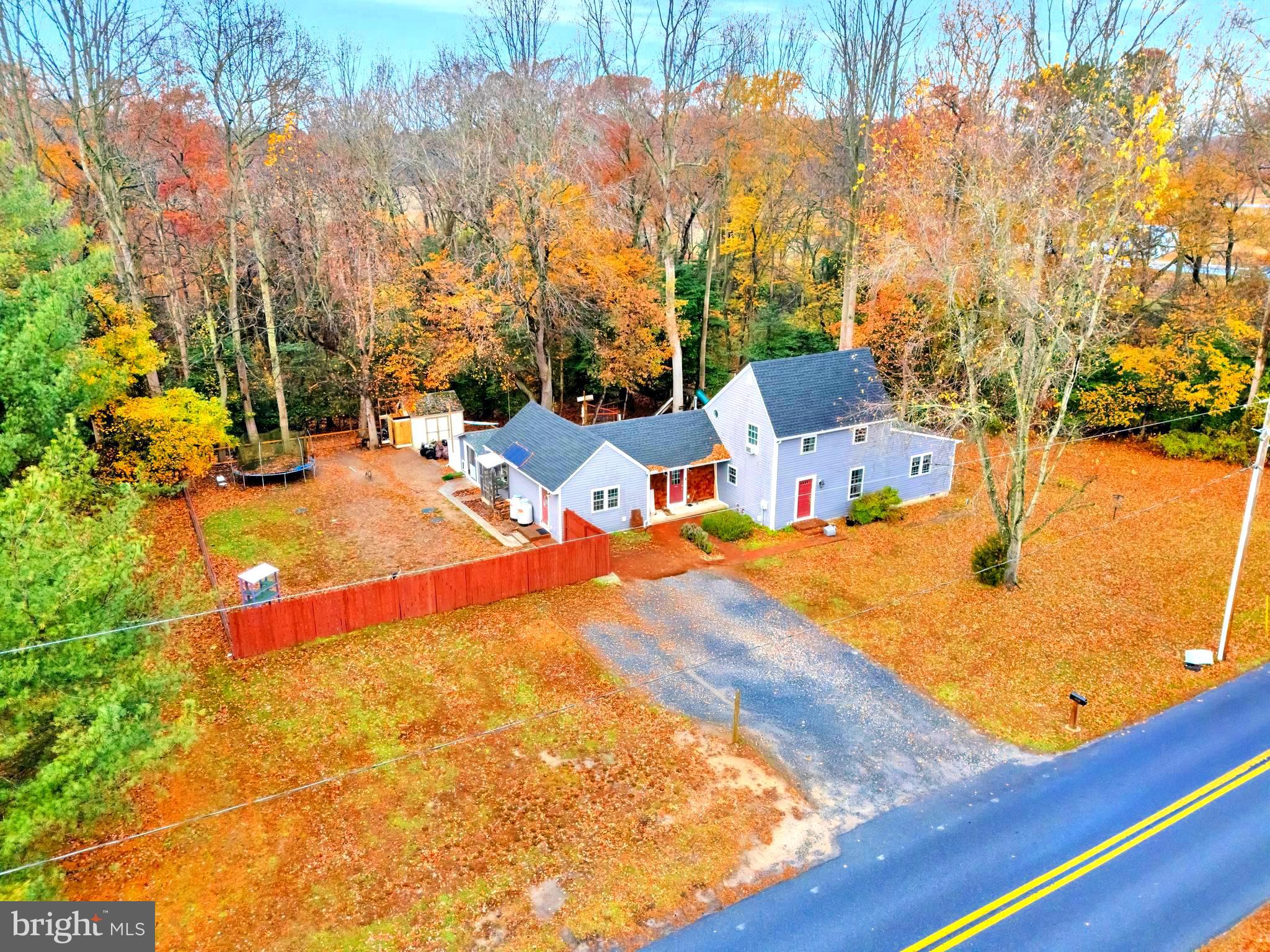 18526 Cool Spring Road Milton, DE 19968 - Photo 2 of 70 a backyard of a house with table and chairs under an umbrella