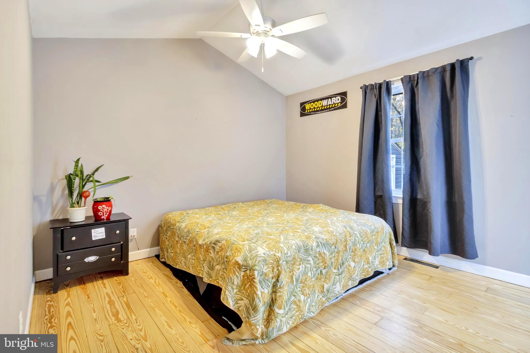 18526 Cool Spring Road Milton, DE 19968 - Photo 27 of 70 a bed sitting in a bedroom next to a window and a chandelier