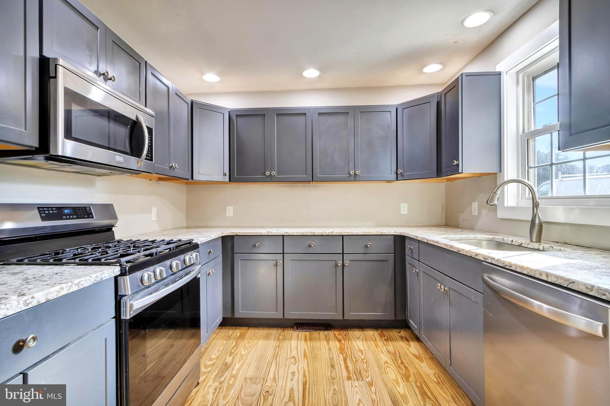 18526 Cool Spring Road Milton, DE 19968 - Photo 10 of 70 a kitchen with stainless steel appliances granite countertop a sink stove and microwave