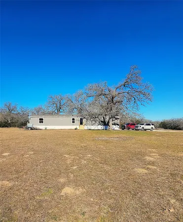 a view of a pool with a house