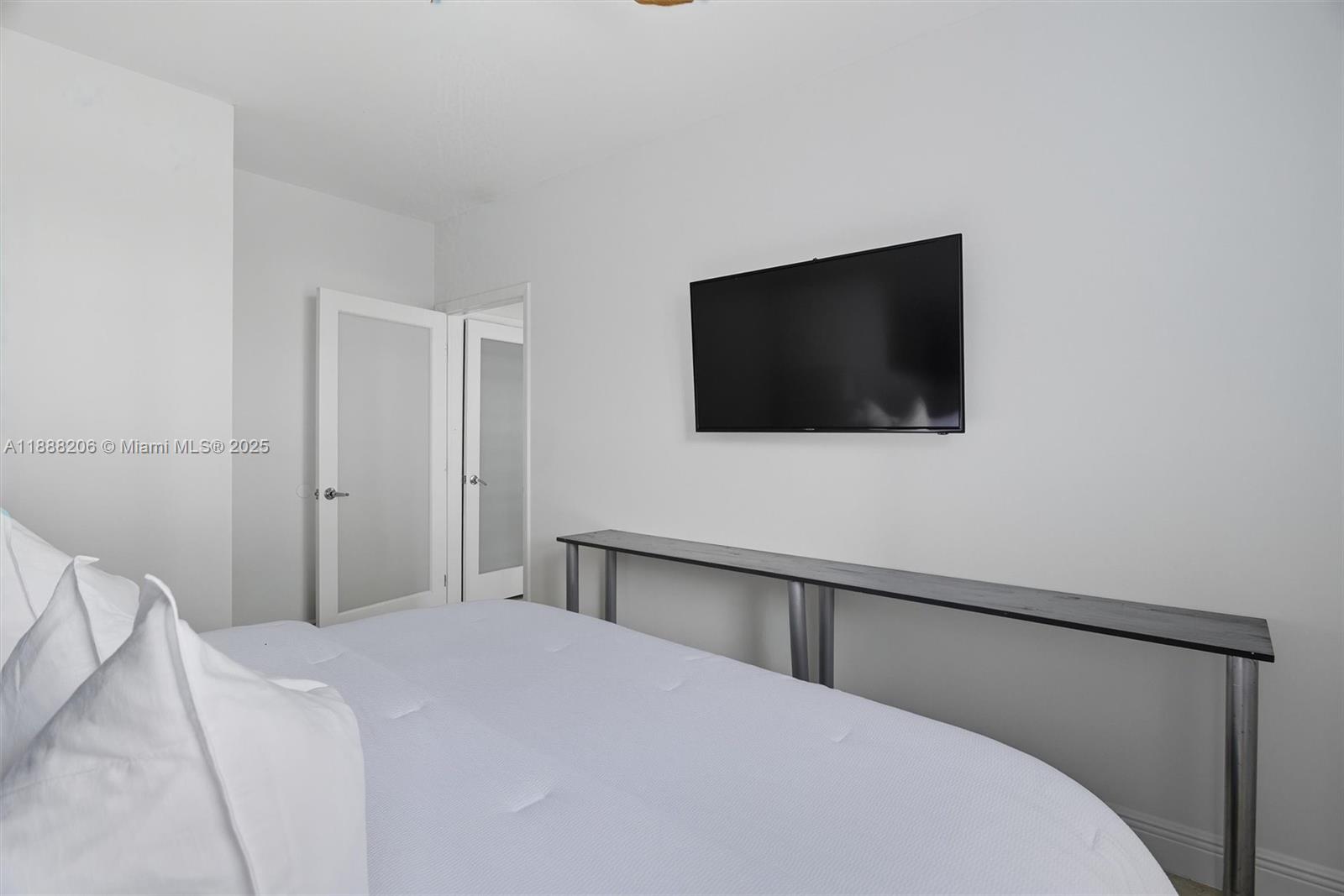 185 Southeast 14th Terrace, Unit 1709 Miami, FL 33131 - Photo 12 of 31 a bedroom with a bed and a flat screen tv