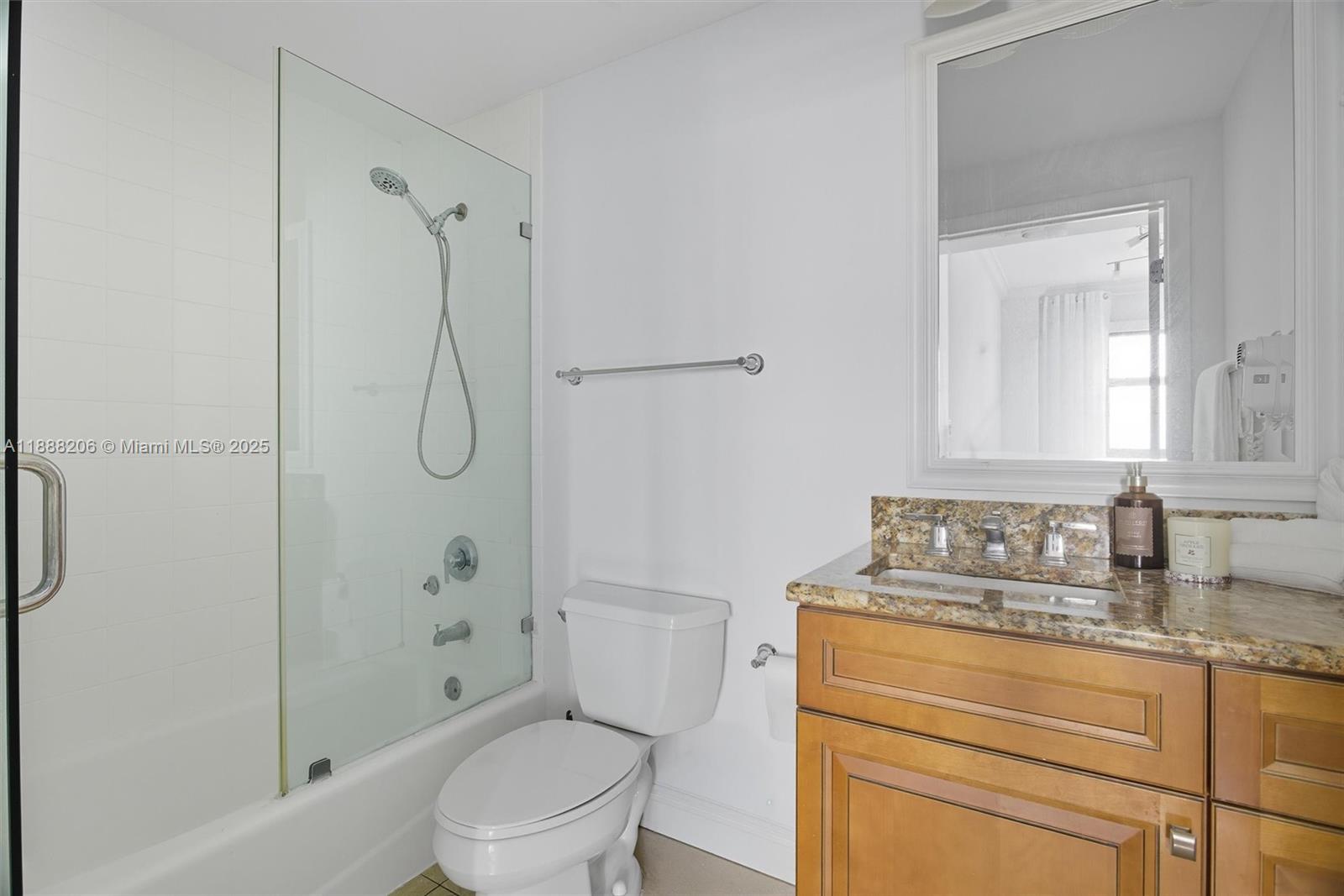 185 Southeast 14th Terrace, Unit 1709 Miami, FL 33131 - Photo 13 of 31 a bathroom with a granite countertop sink toilet and shower