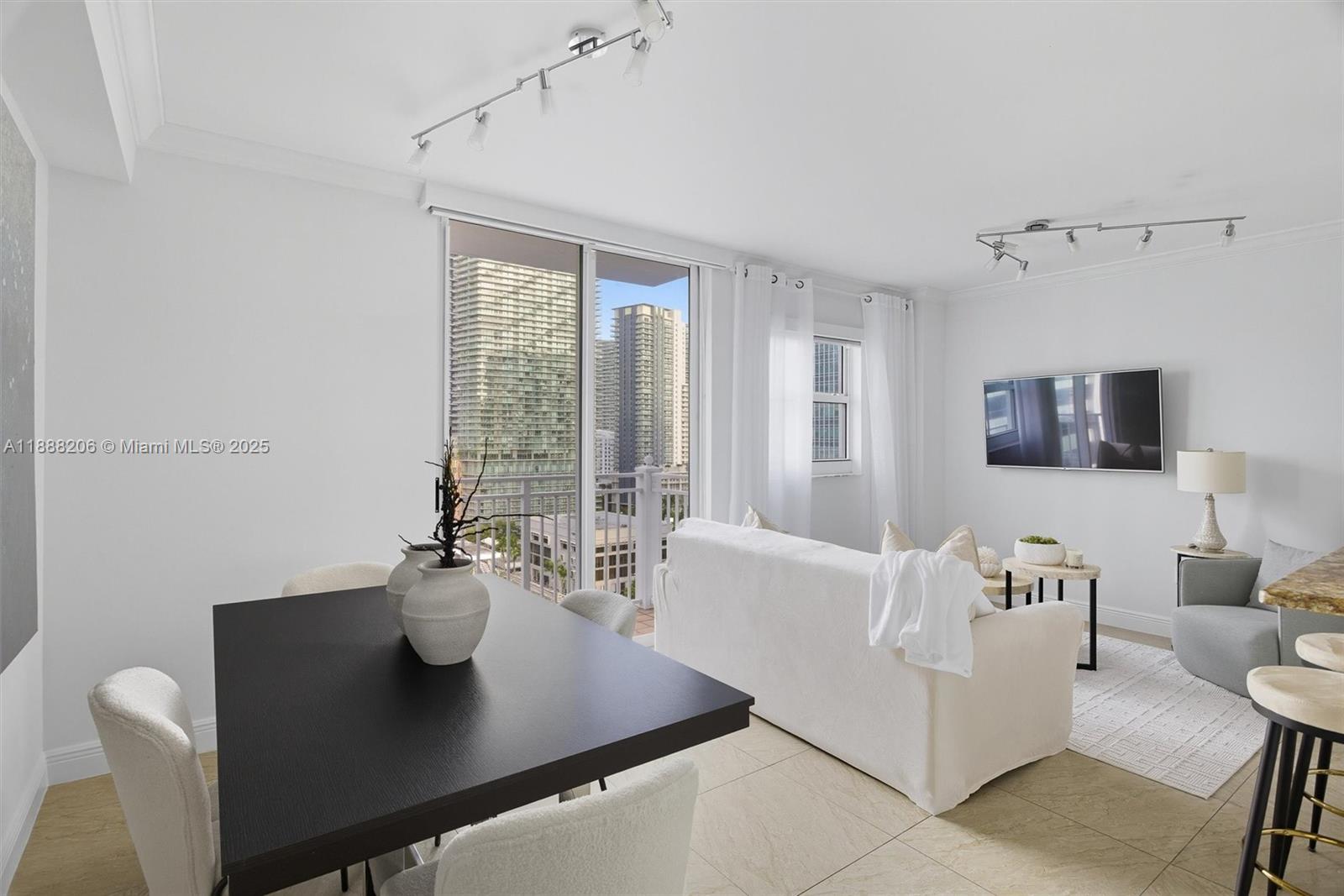 185 Southeast 14th Terrace, Unit 1709 Miami, FL 33131 - Photo 3 of 31 a view of a dining room with furniture and a window