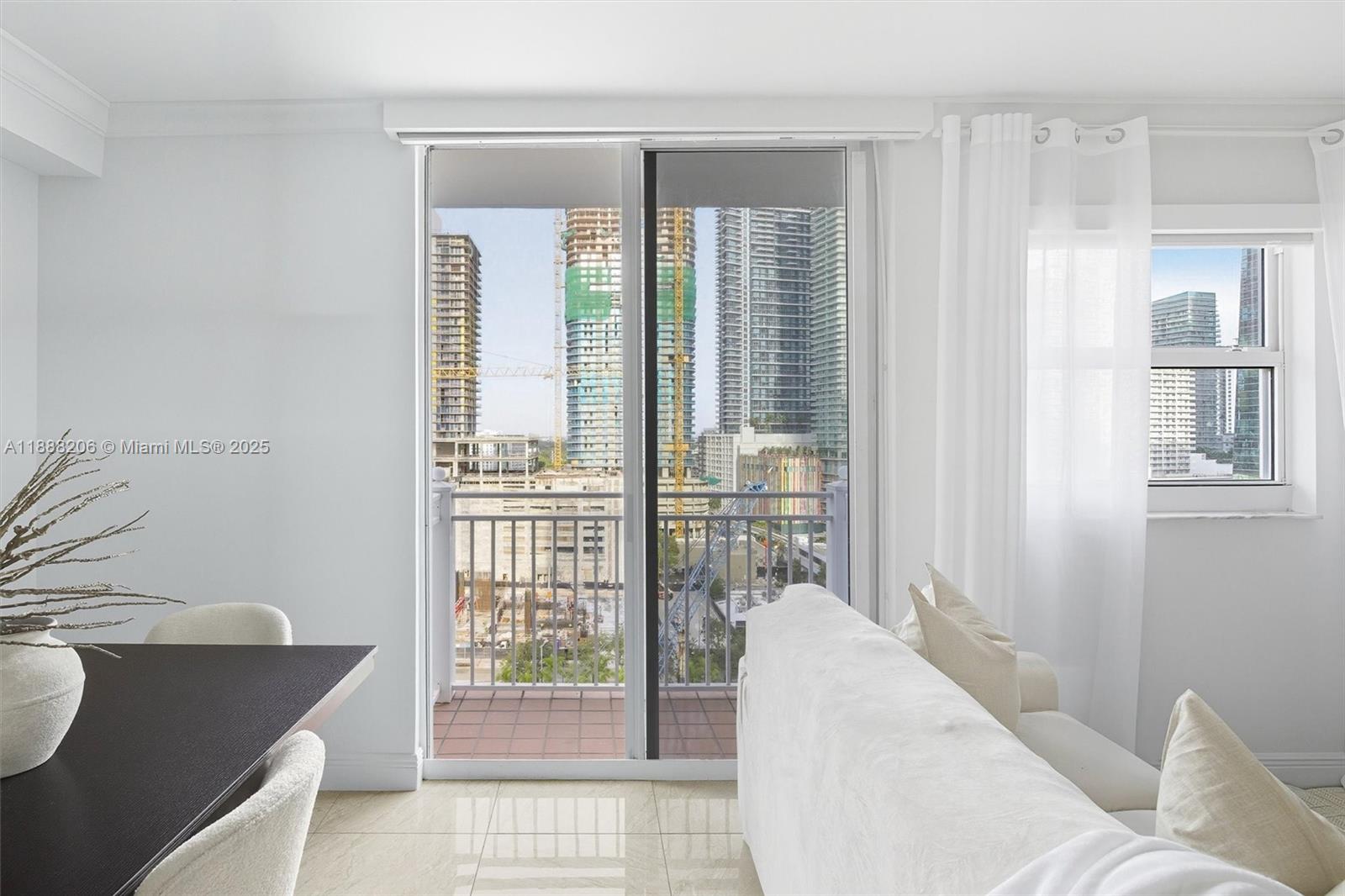 185 Southeast 14th Terrace, Unit 1709 Miami, FL 33131 - Photo 4 of 31 a living room with furniture and a window