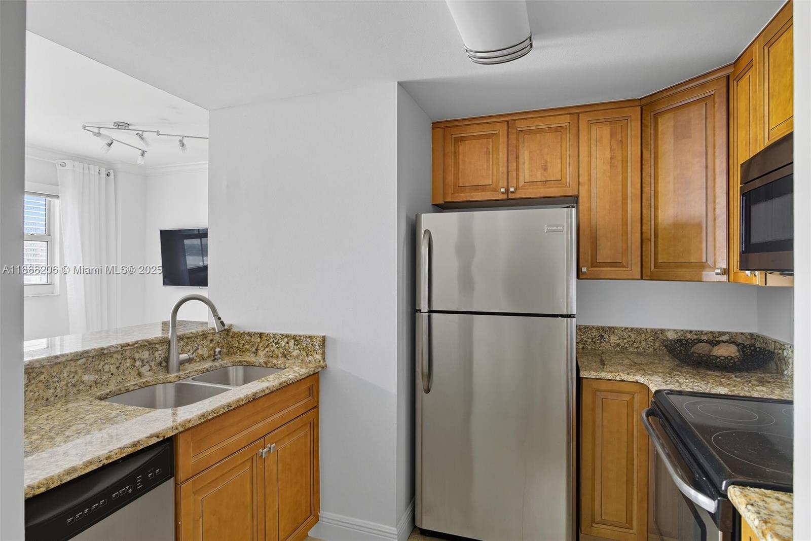 185 Southeast 14th Terrace, Unit 1709 Miami, FL 33131 - Photo 8 of 31 a kitchen with a refrigerator sink and stove