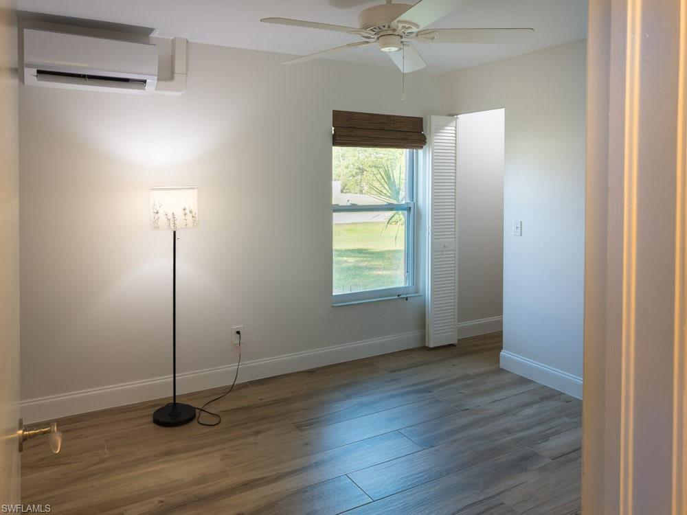 8382 Butternut Road Fort Myers, FL 33967 - Photo 12 of 19 a view of an empty room with wooden floor and a window